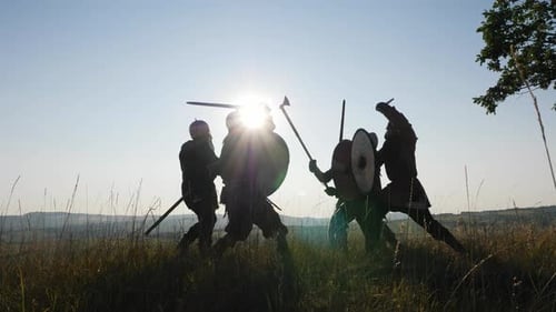 Silhouetted Warriors in Medieval Combat on Hillside