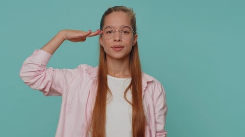 Smiling Young Woman Giving a Salute