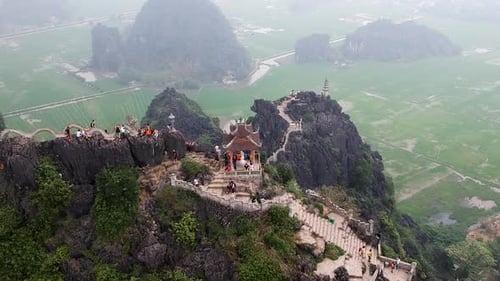 Aerial from the top of Vietnamese dragon temple on top of large limestone karst. Hang Mua, Tam Coc,