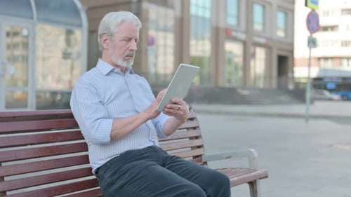 Senior Man Using Tablet in Urban Setting