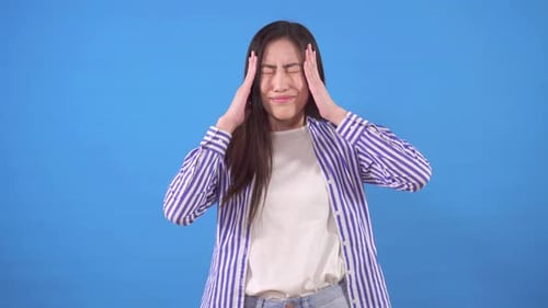 Young Woman Massaging Temples in Discomfort