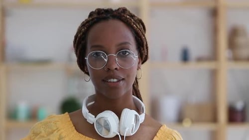 Smiling Woman with Headphones in Home Setting
