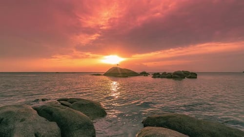 Sea Waves Lash Line Impact Rock on the Beach at Sunset