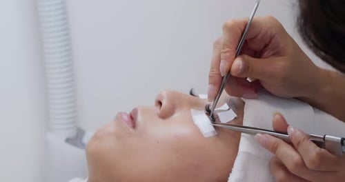 Woman having eye lash extension process