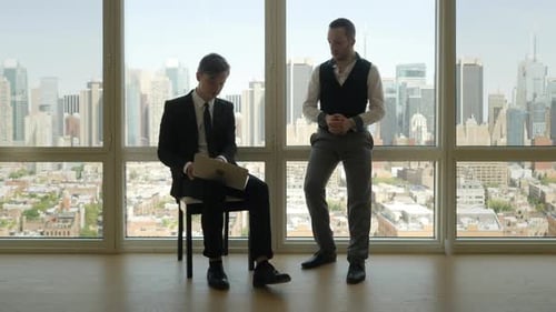 Men Discuss Business in Modern Office Setting