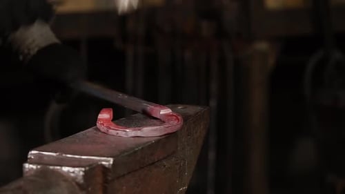 Manually Hot Forging of Horseshoe By Blacksmith in Workshop of Forge