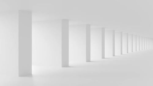 Shadow and light in a large, white, corridor.
