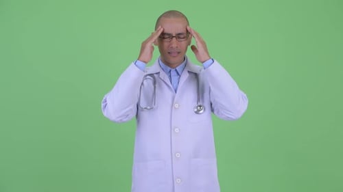 Doctor with Headache or Stress against Green Screen