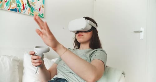 Woman Using Virtual Reality Headset and Controller at Home