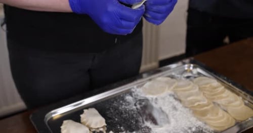 Chef hands close up wrapping handmade pasta making ravioli dumplings meat filled, healthy traditiona