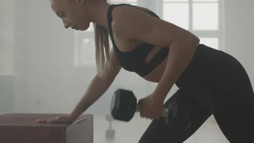 Strong Woman Working Out With Dumbbell