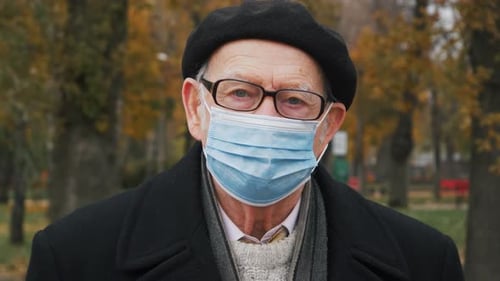 Pandemic, portrait of elderly senior wearing protective mask on street. covid concept health and saf
