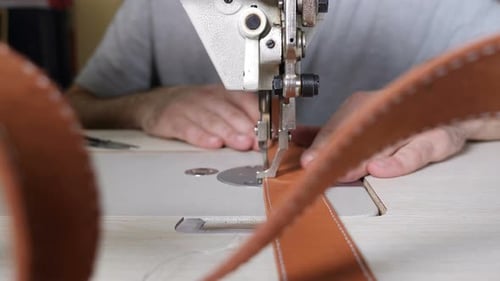Craft Leather Workshop and Manufacture. Close-up of Master Sewing Pieces of Leather, Stitches Straps