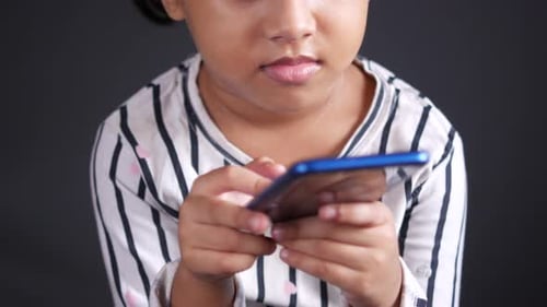 Child Girl Hand Holding Smart Phone While Sited