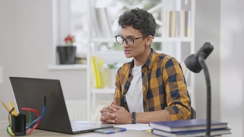 Young Adult on Video Call Indoors at Desk