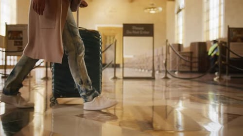 Businesswoman Walking with Suitcase on Wheels By Bus Subway or Railroad Station