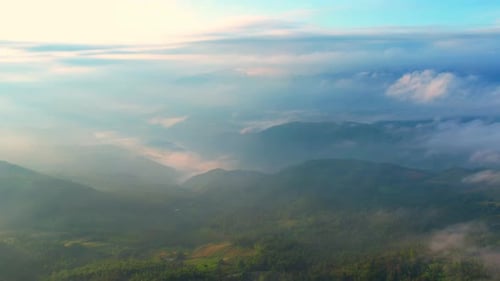 4K Flying through the clouds above mountain tops