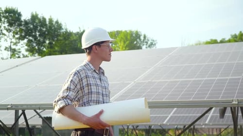 Engineer in a White Helmet Is at the Solar Power Station. The Green Energy Concept