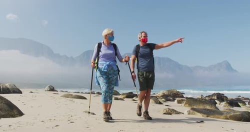 Couple Hiking on Beach with Face Masks