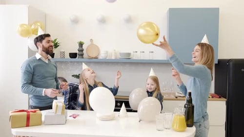 Happy Family Celebrating Birthday with Balloons and Cake