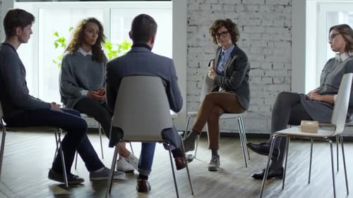 Adults in Group Therapy Session in Bright Room
