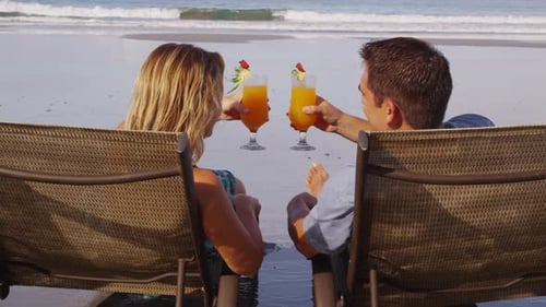 Couple with tropical cocktails at beach. Shot on RED EPIC for high quality 4K, UHD, Ultra HD resolut