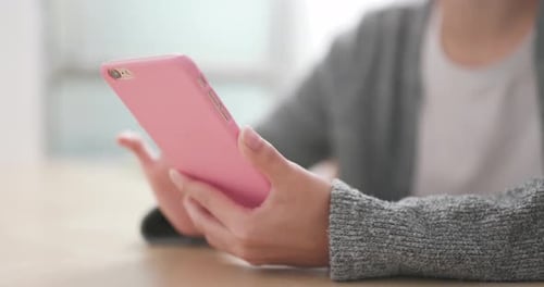 Adult Using a Smartphone Indoors in Close Up