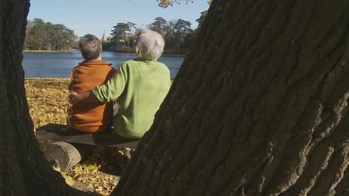 Senior Couple at Lake in Autumn