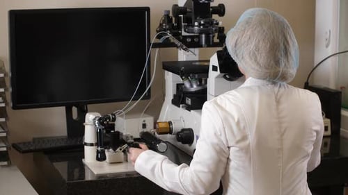Scientist Operating Microscope in Modern Laboratory