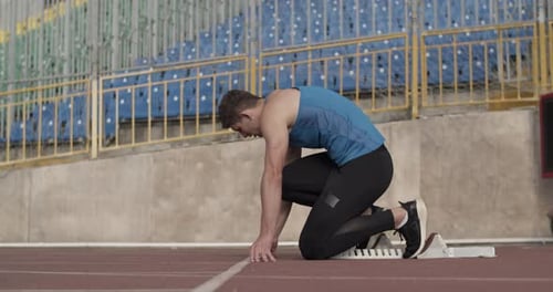 Runner Sprinting Against Stadium Seats