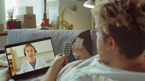 Man on Couch Telehealth Consultation About Medication