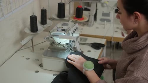 Woman Sewing on Modern Sewing Machine