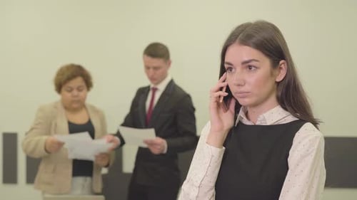 Young Woman Talking on Phone in Corporate Setting