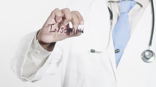 Doctor Writes Insomnia Diagnosis with Marker