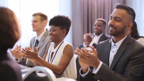 Audience Applauding a Speaker at a Conference