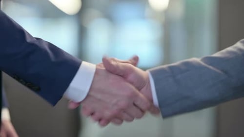 Businessmen Shaking Hands in Modern Office Setting