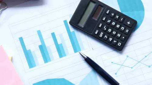 Financial Graph Calculator and Notepad on Table