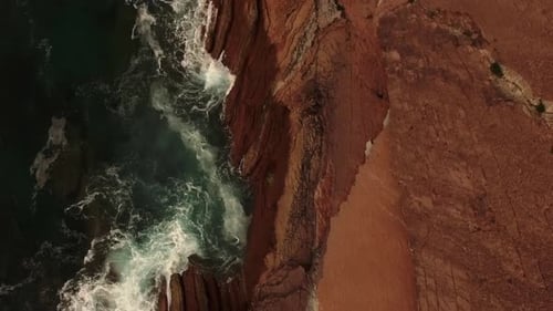 Stormy sea waves splashing on rocky cliff