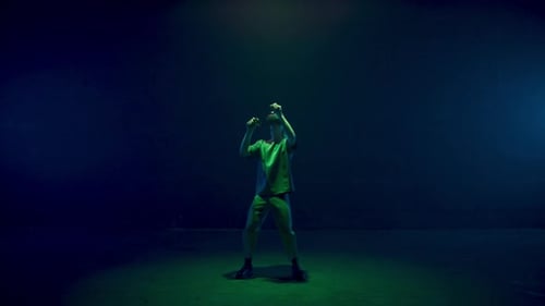 Young Adult Playing Virtual Reality Game in Colorful Lights