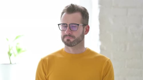 Man with Glasses Looking at Camera in Home