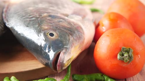 Raw Fresh Fish on a Chopping Board for Preparing for Cooking on Table