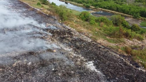 Burning Landfill Emitting Smoke in a Rural Area