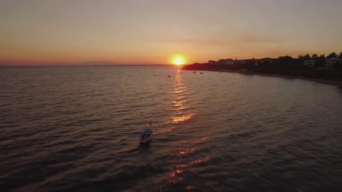 Aerial Sunset Scene of Sea with Boats and Resort on the Coast, Greece