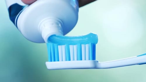 Toothpaste Being Squeezed Onto Toothbrush Close Up