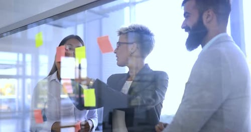 Picture of Designers Sticking Notes in Office