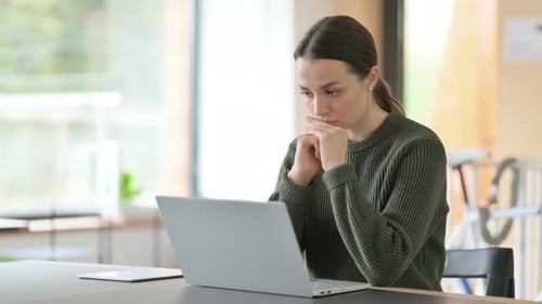 Woman Working with Laptop at Desk