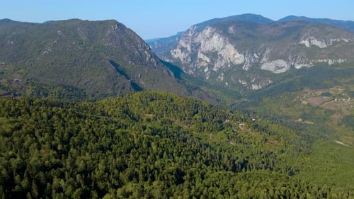 steep green mountains, deep forest and mountain road, beautiful valley