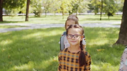Cute Diverse Kids Smiling and Posing for Camera One by One in Park