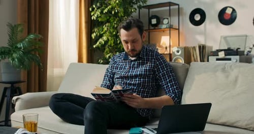 A Man Watches a Foreign Film on His Laptop Notes New Vocabulary Check the Meaning in the Dictionary