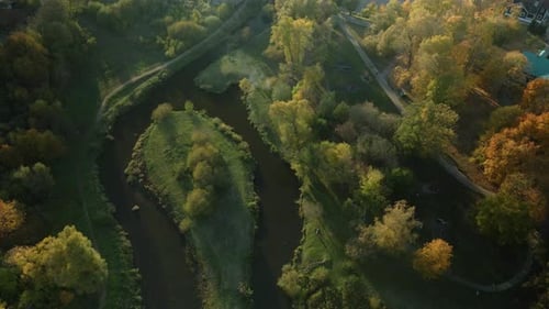 Park area. A winding river. Trees with yellow autumn leaves are visible. Aerial photography.